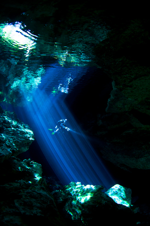 Mesmerizing light piercing through a sink hole in a Mexican cenote