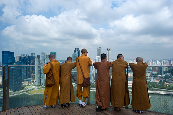Contrasting the old and the new. Chinese monks take in the views of Singapore